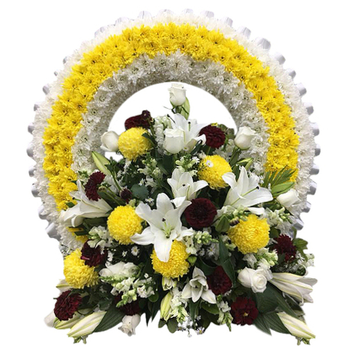 Yellow chrysanthemums representing friendship & hope, ride along a white ringed path. Splashes of red carnations, white roses & lilies suggest love & peace.