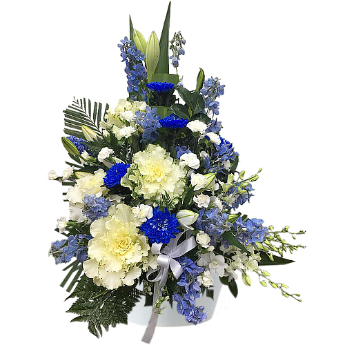 Send off a loved one beyond the skies with graceful display.  Beyond blue features an assortment of white, blue and evergreens. Fresh flower delivery to all south-western suburbs and Sydney throughout.