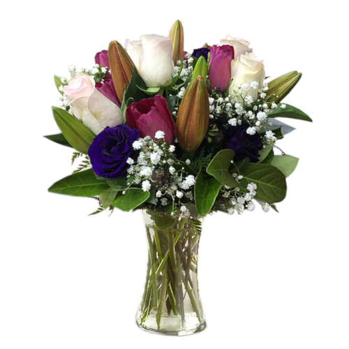 Arrangement of roses & lilies in gorgeous colours of pink, white & blue presented in vase, which will bring cheer to anyone and make that person's day sweeter.