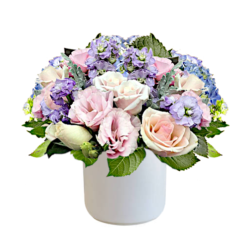 The pastel colour palette basket filled with gorgeous roses and stock flowers in muted pink and purple tones will make the recipient's day sweeter.