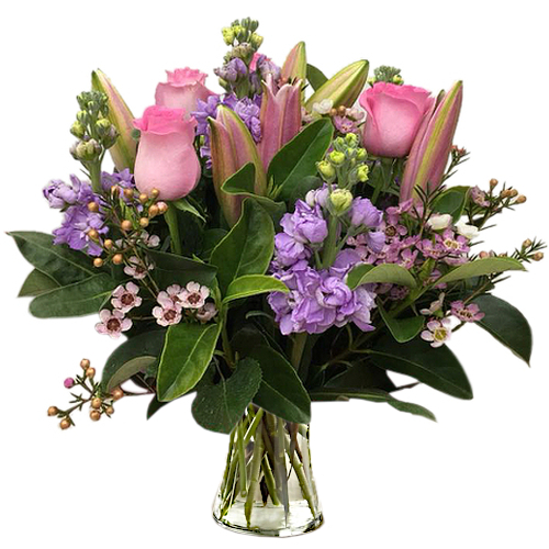 Roses, lilies & snapdragons nestled amongst lush foliage. From pastel pink, to purple & pink, this arrangement is the epitome of fresh with a feminine touch.