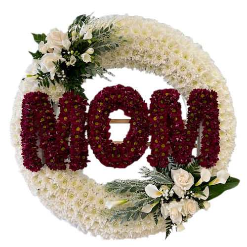 Perfect memorial flowers for cemetery or grave site. Lush chrysanthemum wreath accompanied by beautiful blush pink roses, calla lilies as white as pearl, baby's breathe and assorted greenery.